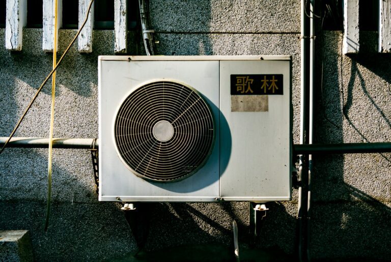 a wall mounted air conditioner mounted on the side of a building