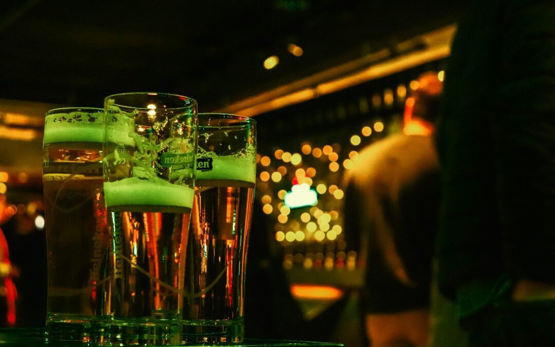 A couple of glasses of green liquid on a table