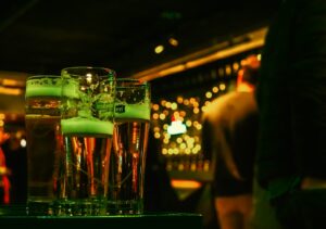 A couple of glasses of green liquid on a table
